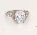 Top front perspective of 3 carat oval lab grown diamond ring showcasing crescent side frames and sparkling facets