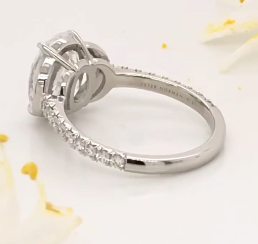 Close-up view highlighting the open-work undergallery bridge and crescent accents on a lab diamond ring