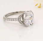 Detailed angle shot displaying the curved micro-pave side motif framing a 3 CT oval cut lab diamond