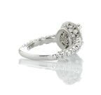 Angled view highlighting the smooth white gold shank and pave diamond shoulders of an oval engagement ring.