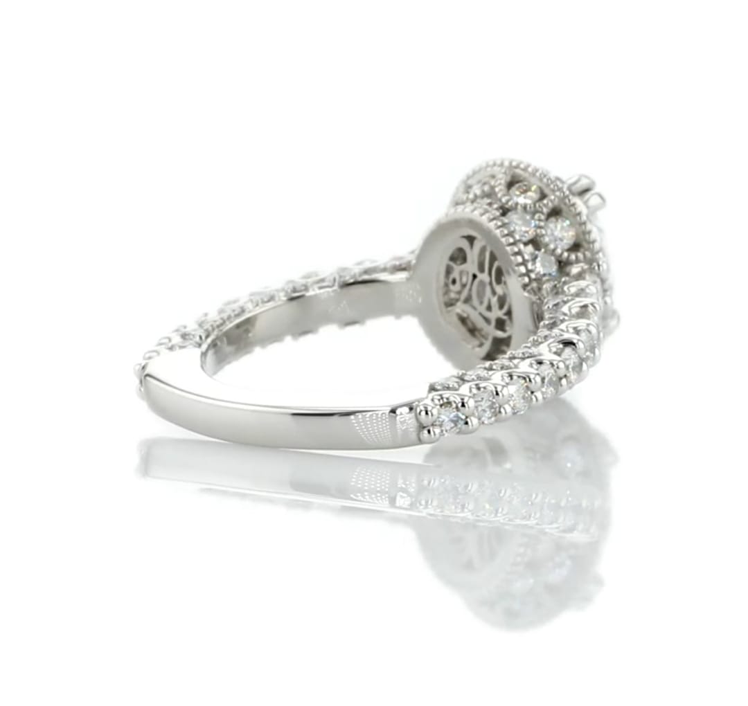 Angled view highlighting the smooth white gold shank and pave diamond shoulders of an oval engagement ring.