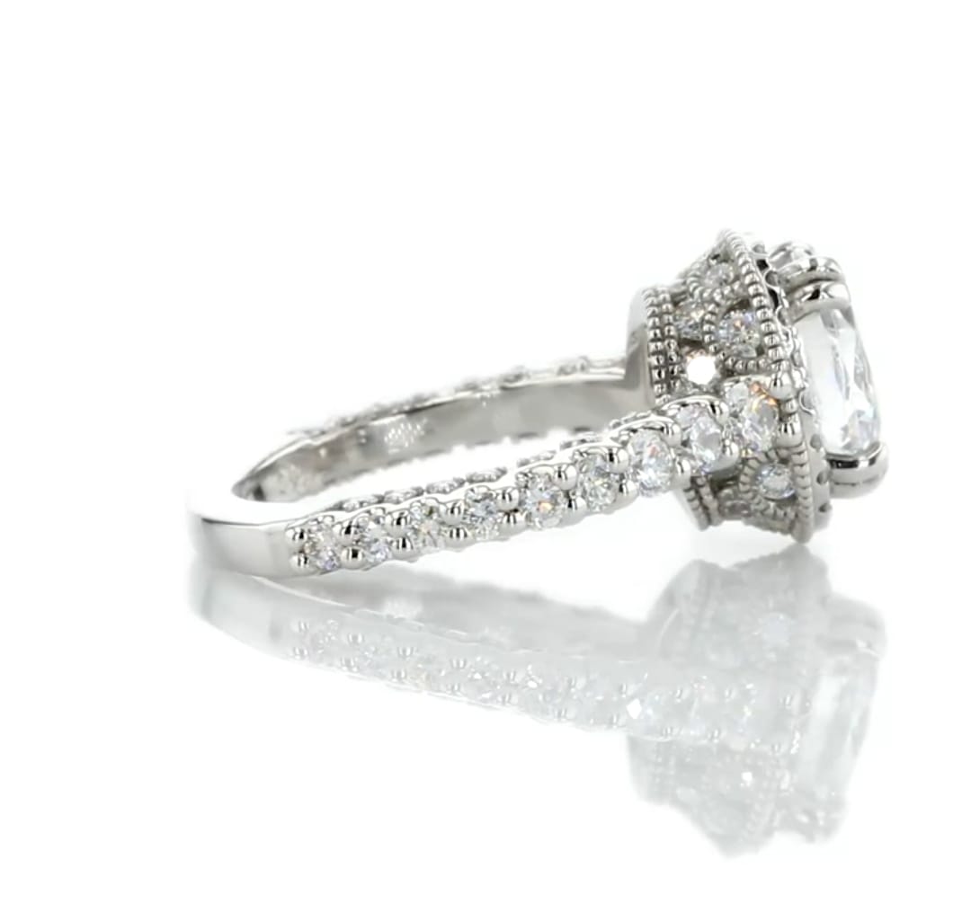 Close-up side view of milgrain halo detailing and diamond accent band on a 2 CT oval lab grown ring.