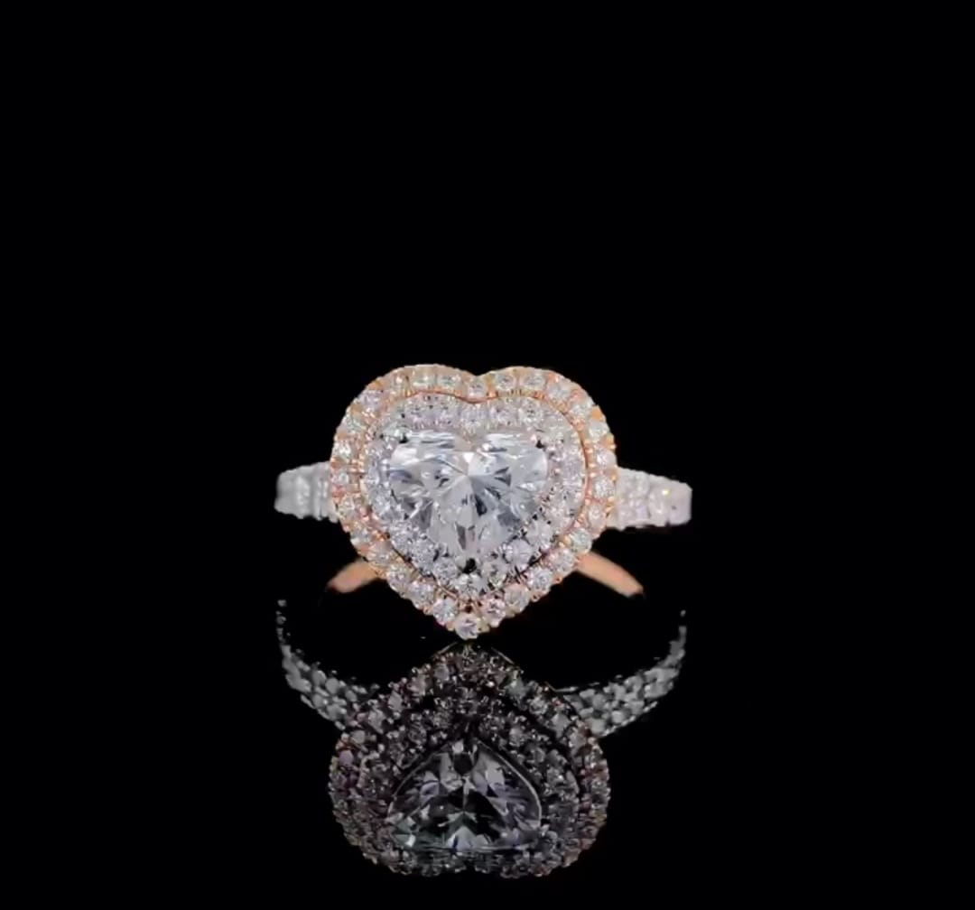 Direct top-down view showing the 2 CT heart cut lab diamond surrounded by a double halo frame on a sleek black background.