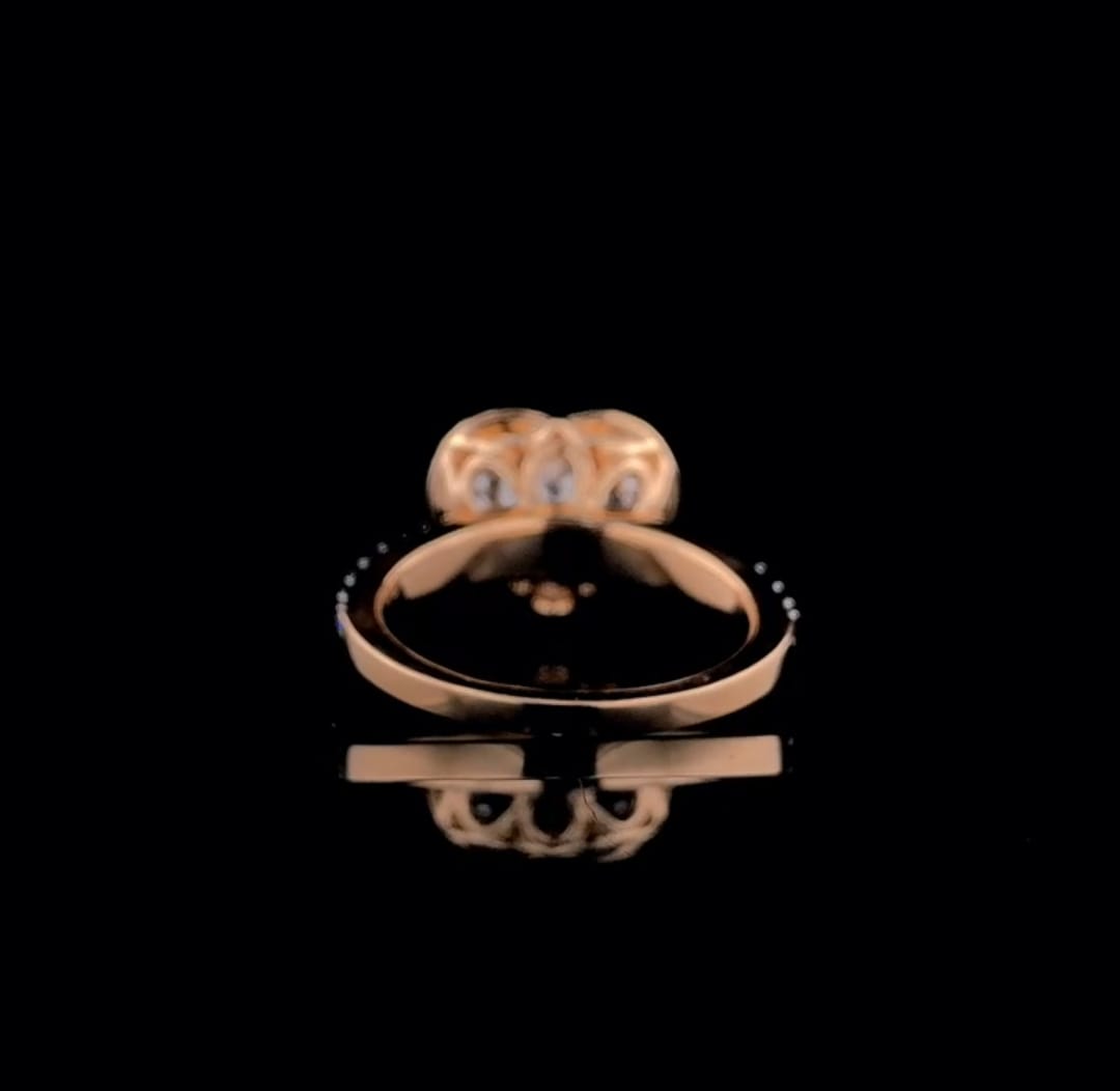 Underneath view displaying the polished rose gold band and back of the heart-shaped halo setting.