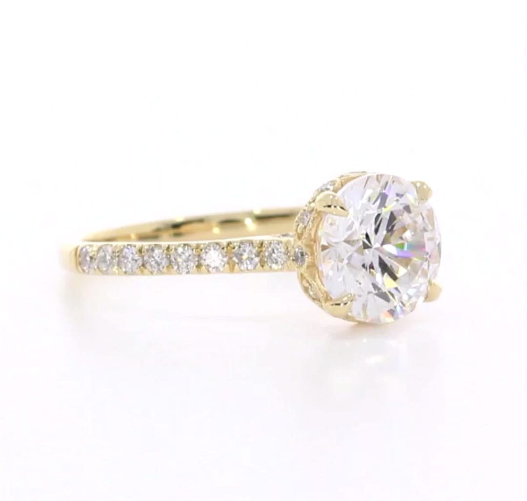 Side angle of 3 CT round lab grown diamond ring in yellow gold with pavé band