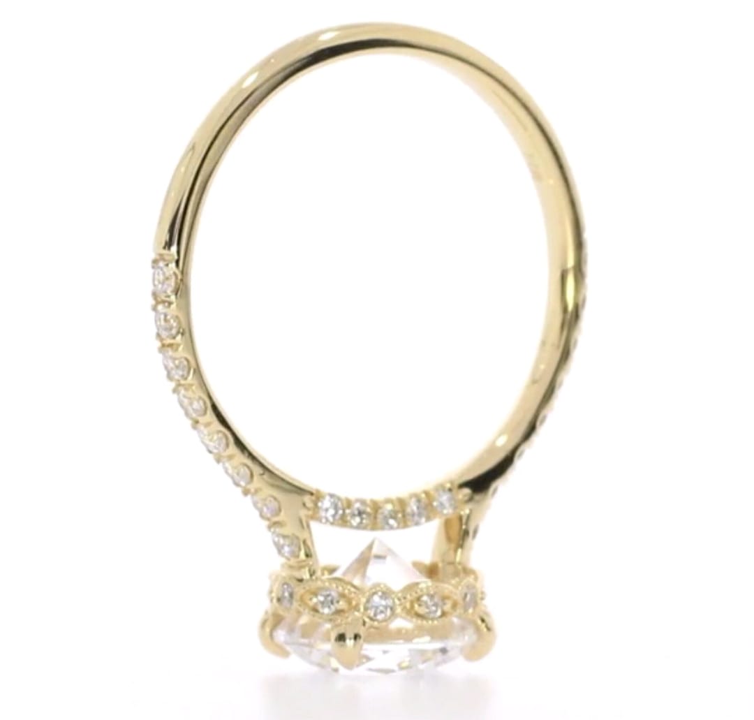 Clear view of intricate ornate gallery and pavé band on yellow gold diamond ring