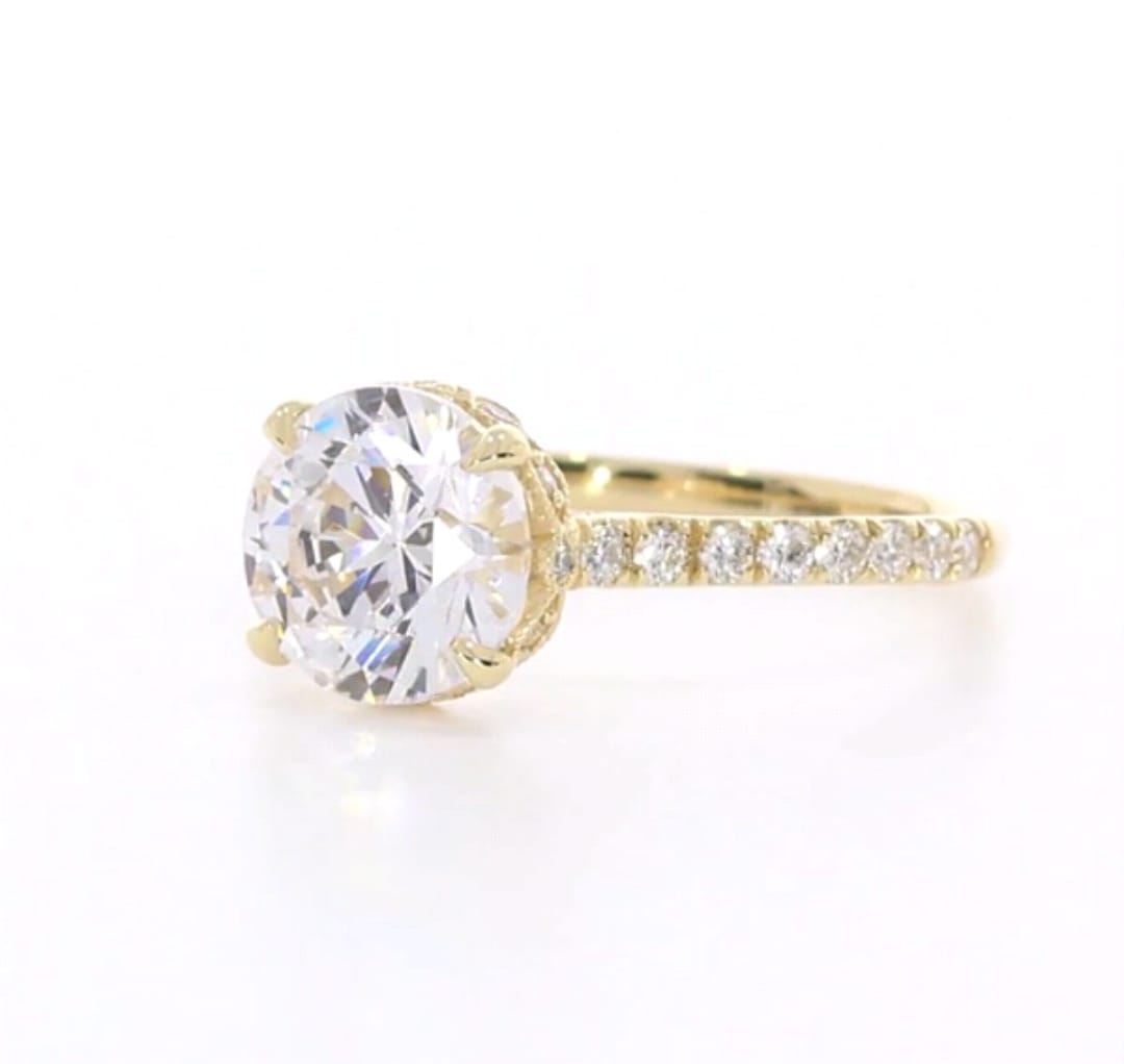 Angled side view showcasing center diamond brilliance and yellow gold pavé band