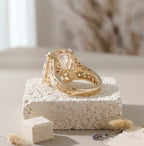 Rear angle view of a yellow gold engagement ring showing intricate filigree cut-outs on the under-gallery and band.