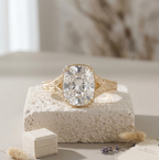Straight-on front view of a vintage-style yellow gold engagement ring featuring a large cushion-cut center stone.