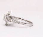 Side view of white gold engagement ring featuring pavé diamond band and scalloped halo