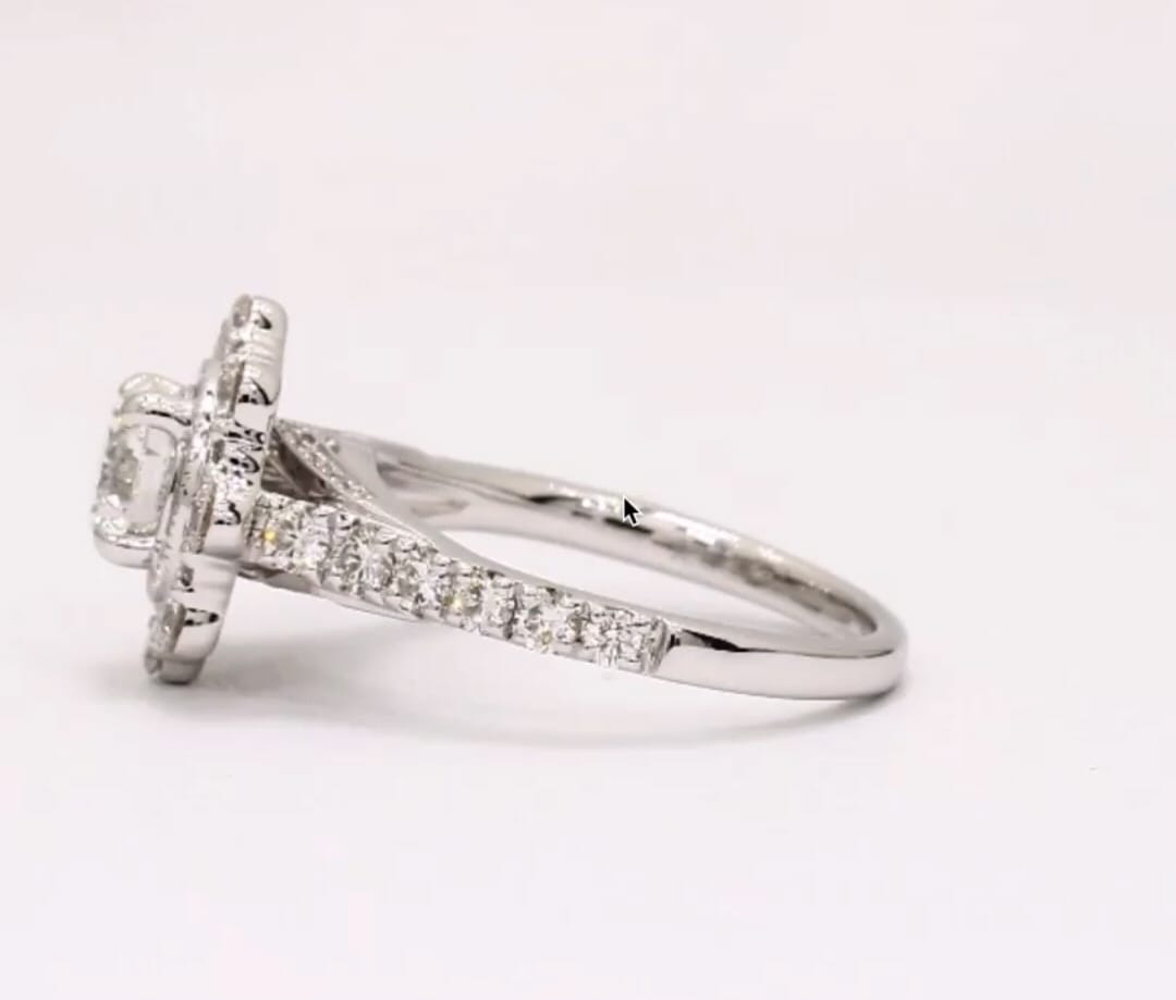 Side view of white gold engagement ring featuring pavé diamond band and scalloped halo