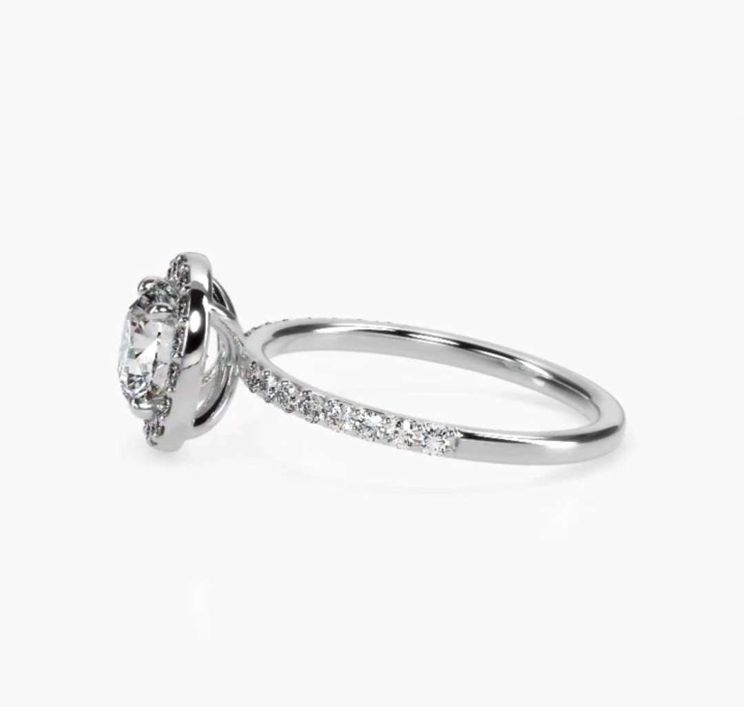Profile view showcasing slim white gold micro-pavé band and round halo setting