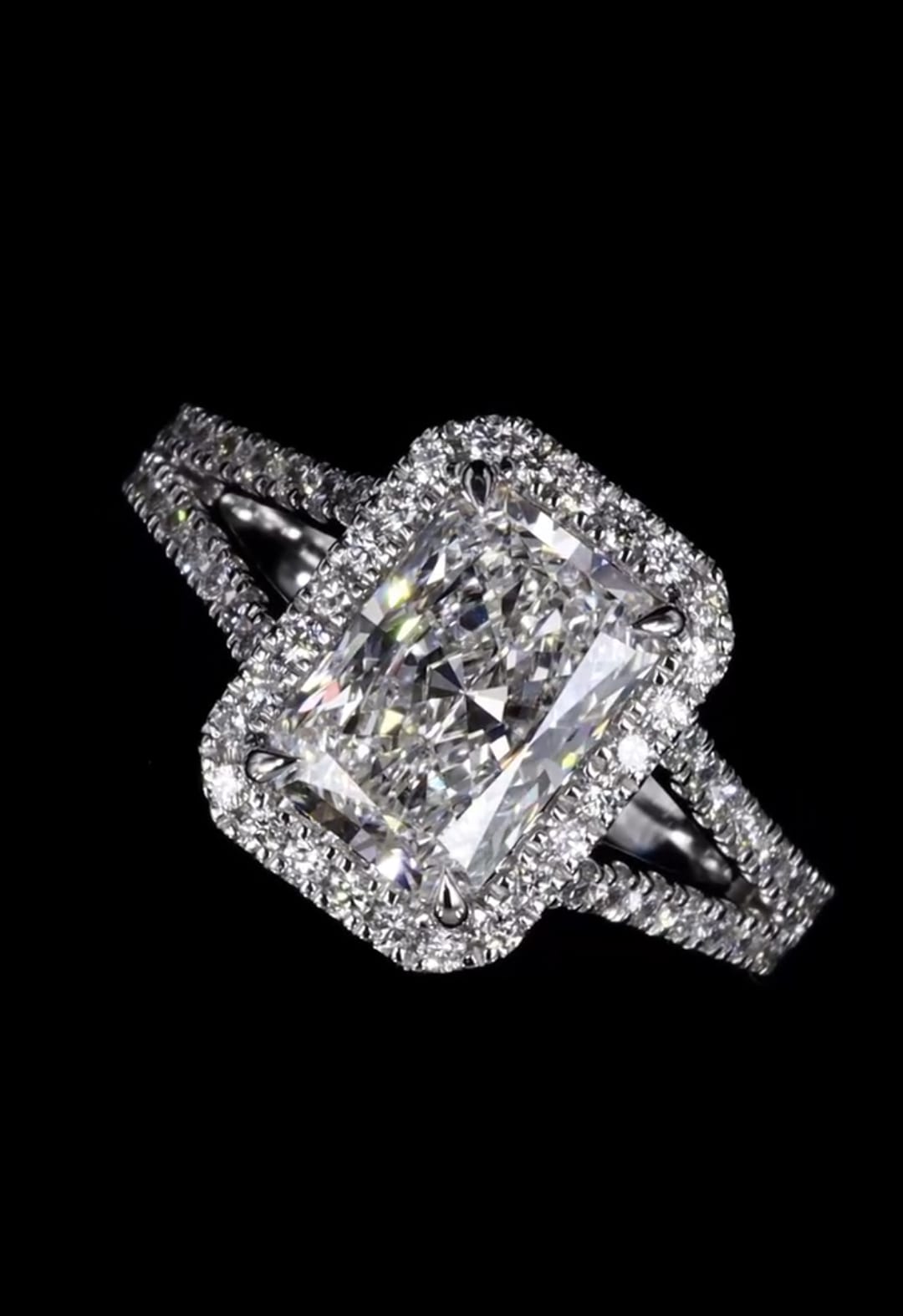 Close-up top view of 3 CT radiant cut lab diamond with glowing halo on black reflection
