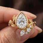 Top view of 2 CT pear cut bezel lab grown diamond ring featuring nature-inspired leaf and cluster accents.