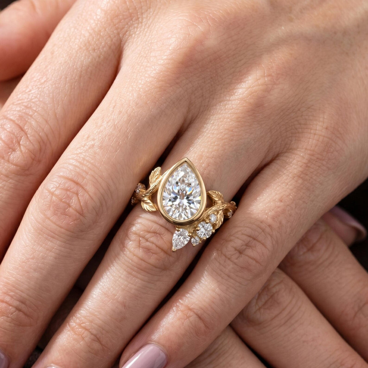 Front on-hand view showcasing a 2 carat pear cut lab grown diamond botanical leaf ring.