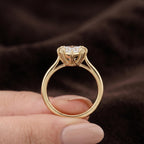 Handheld view showing a 3 CT heart shape lab grown diamond in a multi-claw gold bezel setting.