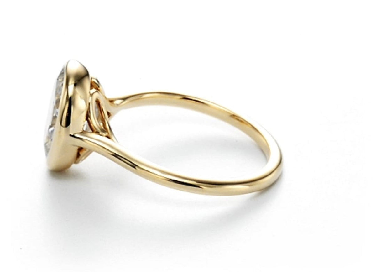 Direct side profile view showing the height and open basket wire details of an oval bezel engagement ring.