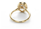 Angled under-basket view revealing the light-entry cutouts under the 2 CT oval lab grown diamond ring.