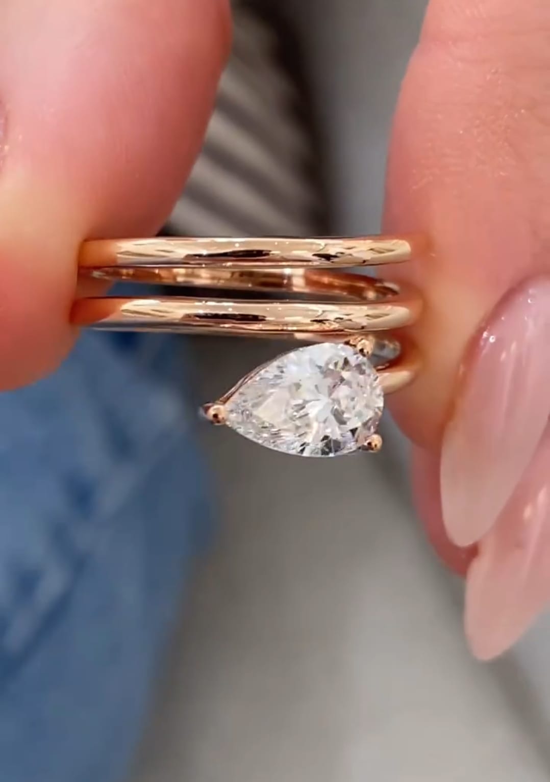 Close-up macro view highlighting the prong setting and facet brilliance of a 1.50 CT pear-shaped lab grown diamond on a rose gold wrap ring.