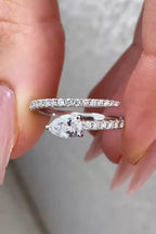 Macro view showing the brilliant clarity of an East-West 1.5 carat pear lab diamond on a pave spiral band.