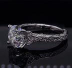 Side angle of 2 carat round lab diamond ring showing Celtic knot shoulders and engraving