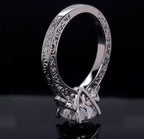 Close-up of carved scrollwork band and head setting on round lab diamond ring