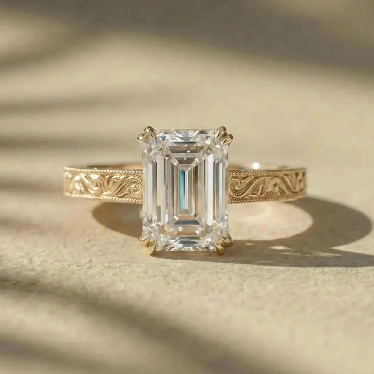 Front view of a 3 ct emerald cut lab grown diamond ring with detailed filigree scrollwork on band