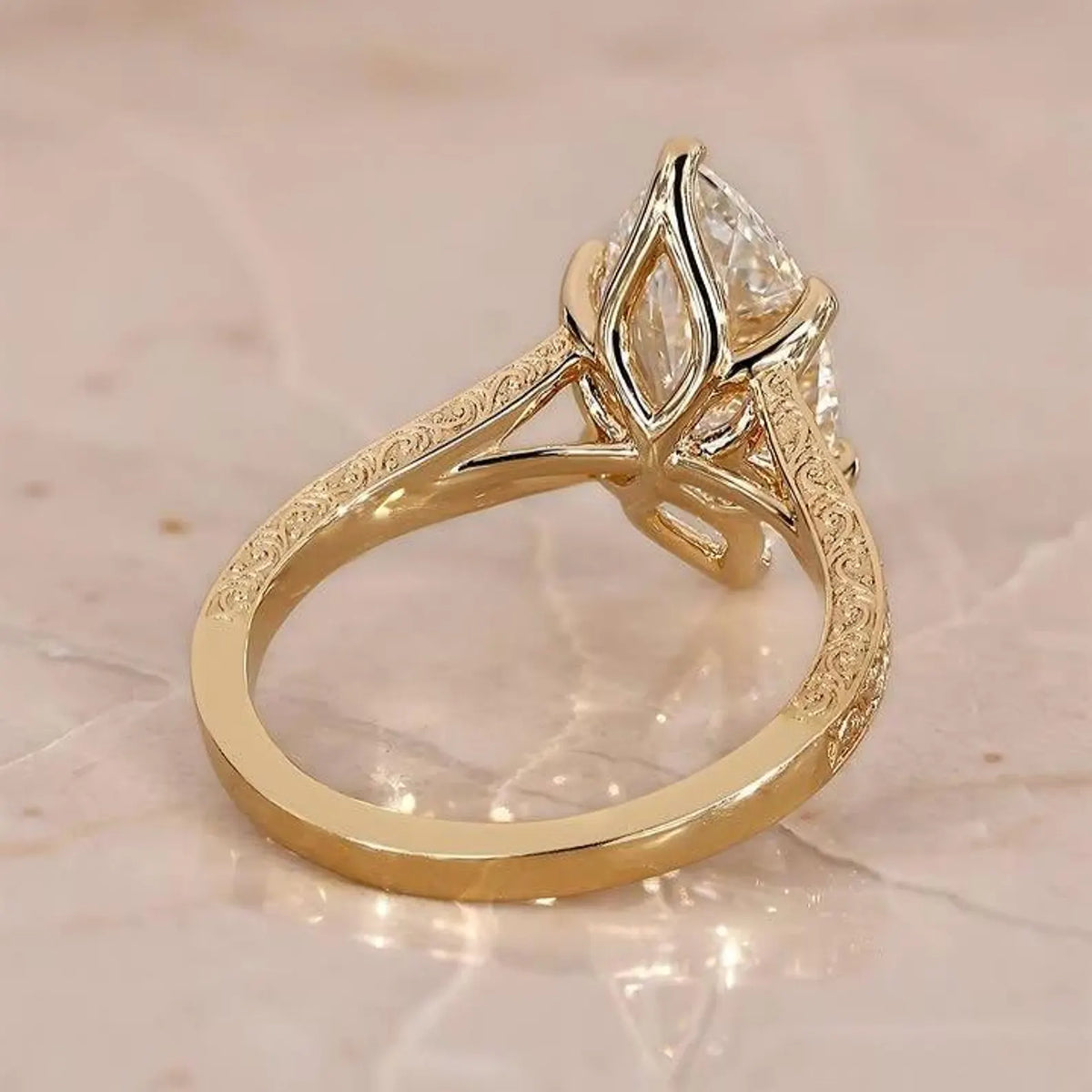Side angle view of 3 CT marquise cut lab grown diamond ring with vintage engraved yellow gold band