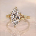 Top-down view of a 3 carat marquise cut lab grown diamond ring on a neutral surface