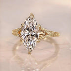 Top-down view of a 3 carat marquise cut lab grown diamond ring on a neutral surface