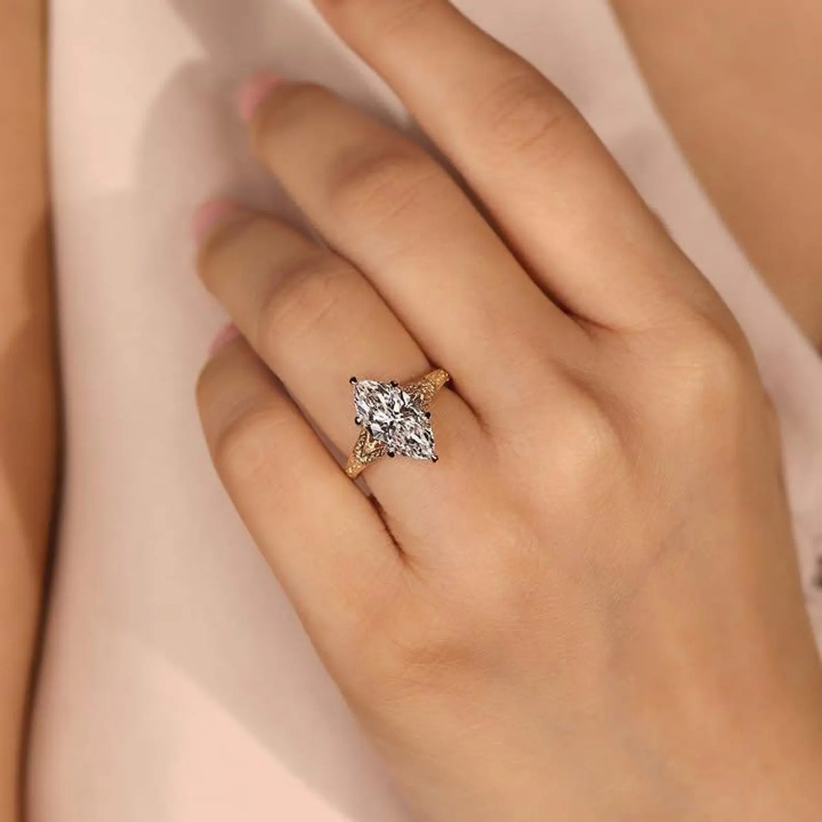 3 CT marquise cut lab grown diamond ring with hand-engraved band worn on a hand