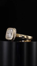Three-quarter view showing the cushion cut lab diamond center stone in a protective bezel setting