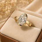 Angled shot of 2 carat oval cut lab diamond bezel engagement ring sitting in luxury ring box