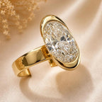 Close-up macro view of 2 carat oval lab diamond bezel setting on a polished wide gold band