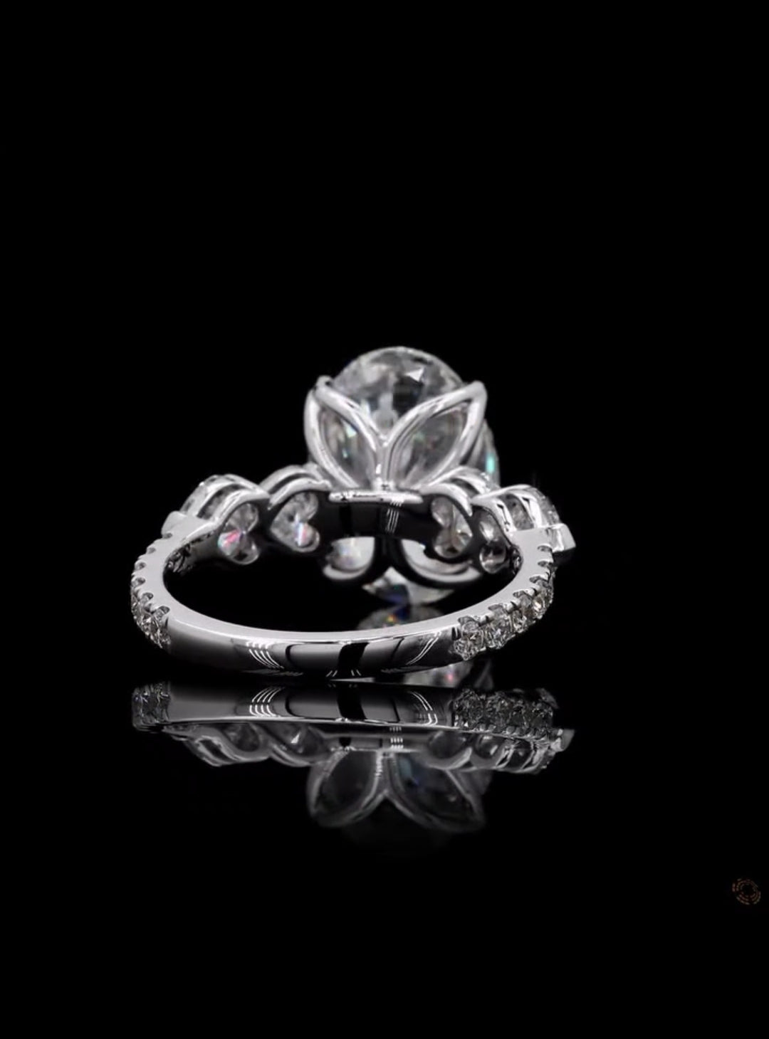 Back view of a 4 carat oval lab grown diamond engagement ring featuring a tulip petal basket and pave band