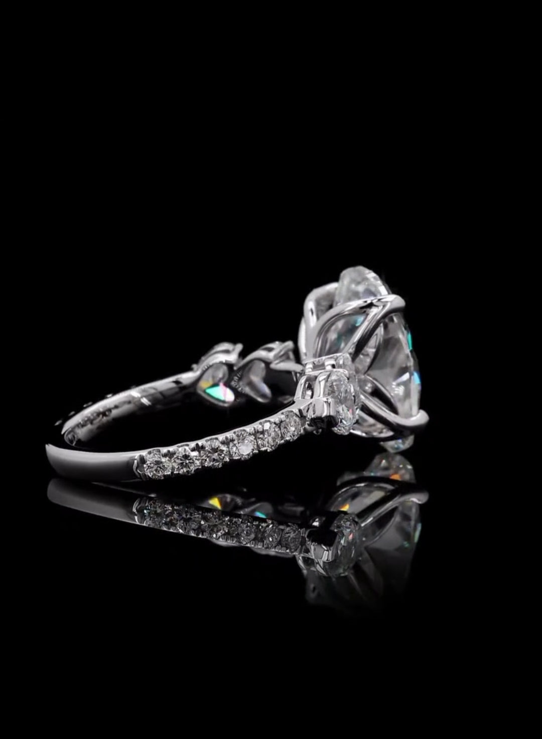 Side profile view highlighting heart-shaped side accent stones and pave band on a lab grown diamond ring