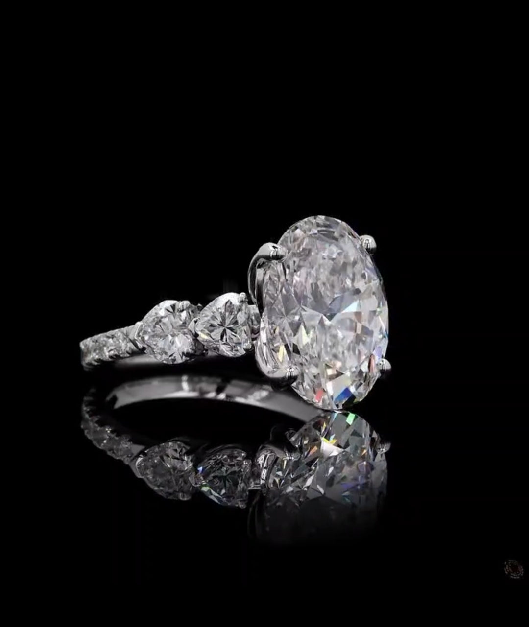 Three-quarter view of a 4 carat oval cut lab diamond engagement ring with heart accents against black background