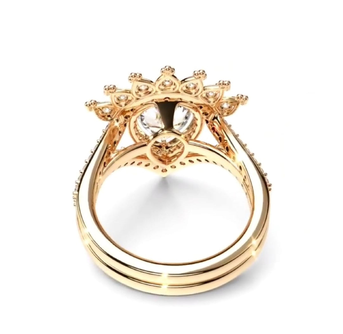 A gold ring with a crown-like floral setting and a clear central gemstone, shown on a plain white background.