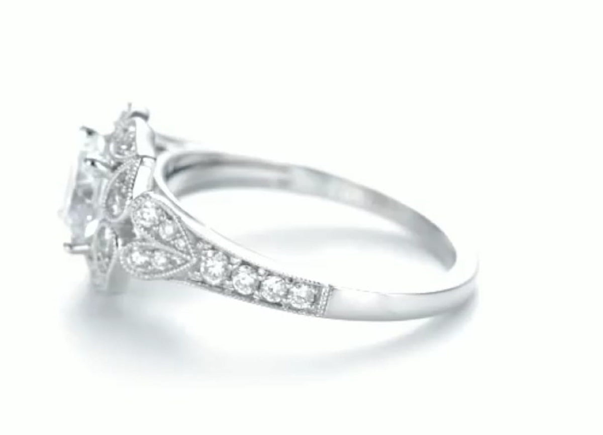 Side profile view showing pave diamond band and milgrain leaf details on 2ct round lab diamond ring