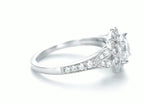 Close-up side view showing milgrain scrollwork and diamond accent placement on white gold vintage halo ring