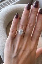 Front view of a 3 carat radiant cut diamond engagement ring worn on finger