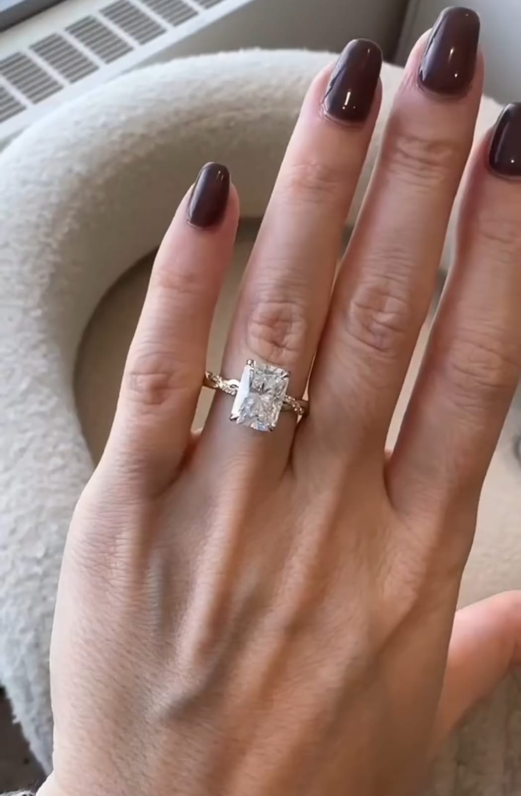 Front view of a 3 carat radiant cut diamond engagement ring worn on finger