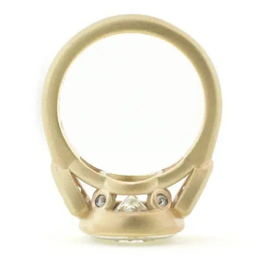Profile view of 4 CT round diamond ring displaying peek-a-boo accent diamonds in gallery.