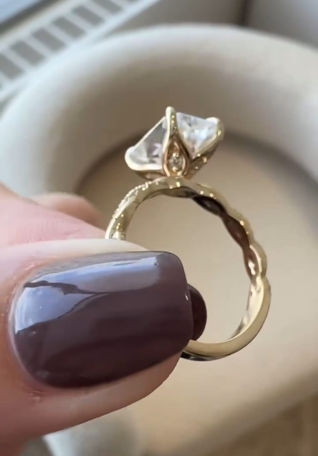 Detailed basket profile showing prong settings and side diamonds on radiant engagement ring