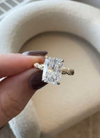 Top-down macro view of a 3 carat brilliant radiant cut lab diamond held between fingers