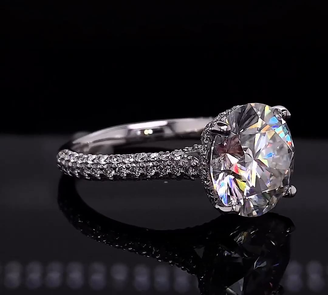 Angle view of 4ct round diamond ring highlighting the hidden halo basket setting