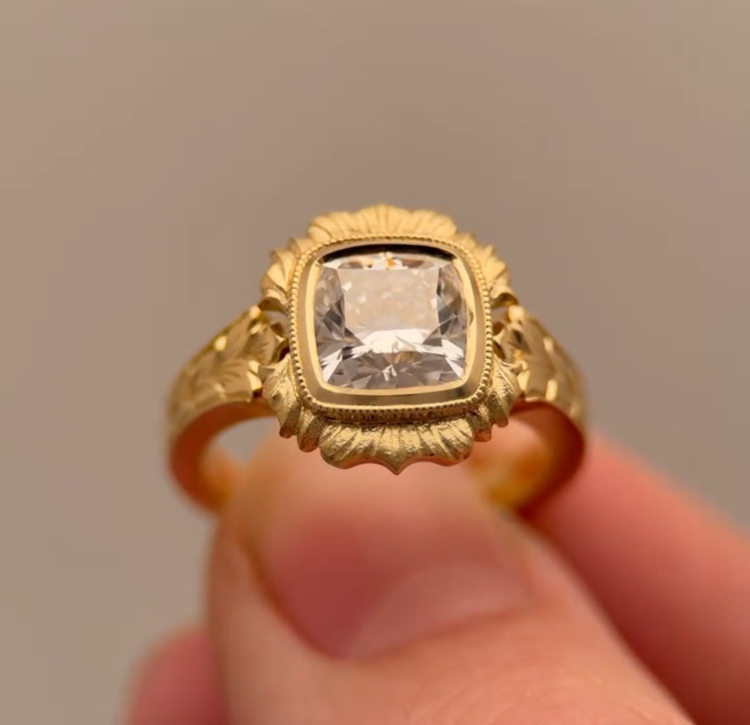 Front perspective of 4 CT cushion cut lab grown diamond in floral scalloped bezel halo frame.