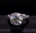 Front view of a 4 carat round brilliant lab diamond ring set on a pave band