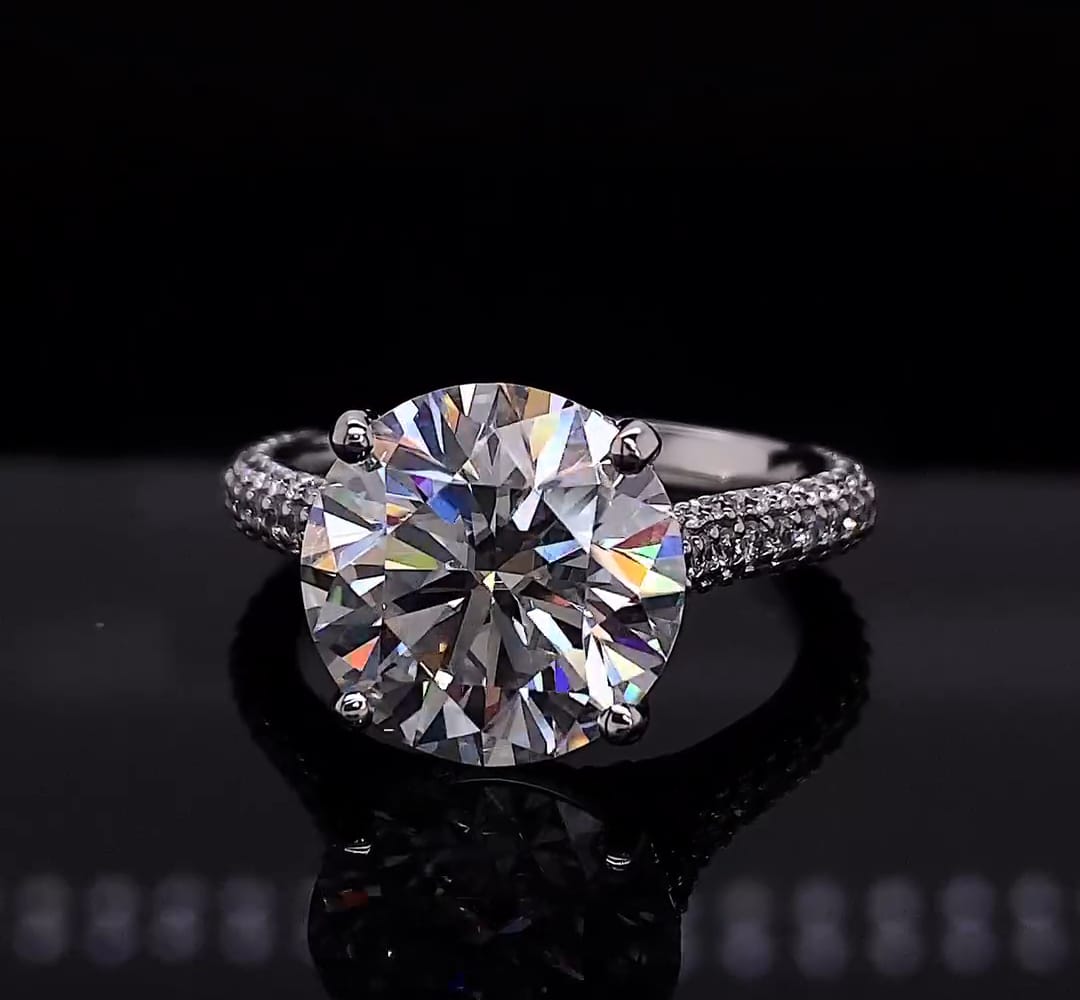 Front view of a 4 carat round brilliant lab diamond ring set on a pave band