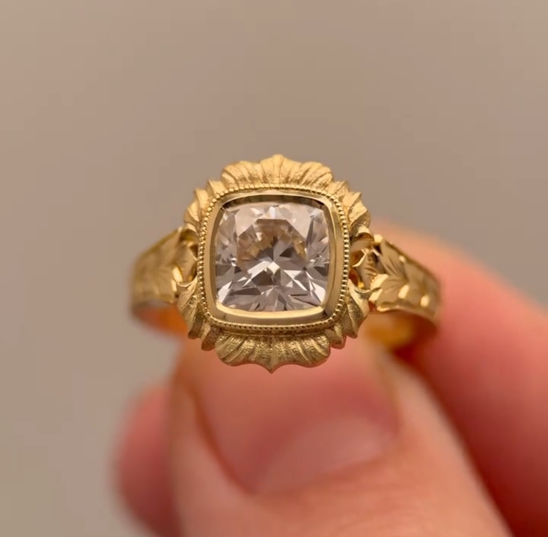 High-detail close-up of 4 CT cushion cut lab diamond set in antique-style scalloped bezel.